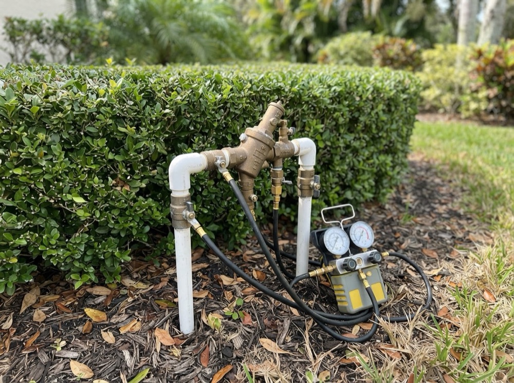 Backflow preventer being tested with a differential gauge (illustrative image)