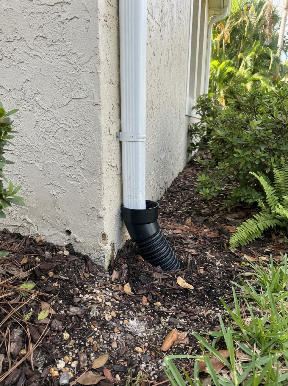 Downspout tied into an underground drain line (illustrative image)