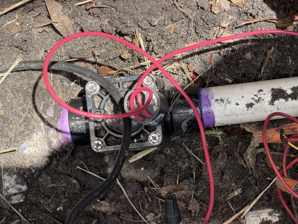 Hunter irrigation valve installed on a purple-primed PVC line
